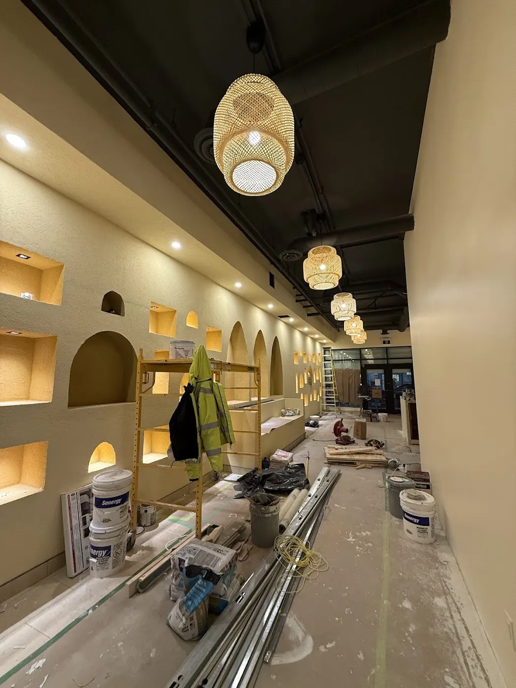 Commercial interior under renovation with pendant lighting and alcove spotlights